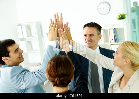 Portrait of business group keeping hands close to each other meaning support Stock Photo
