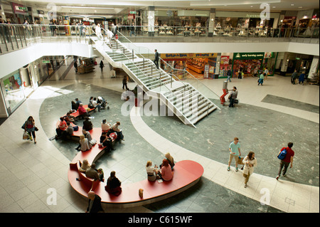 Arndale Centre, Manchester, England. Shoppers and retail outlet stores shops in the pedestrianised city centre shopping mall Stock Photo