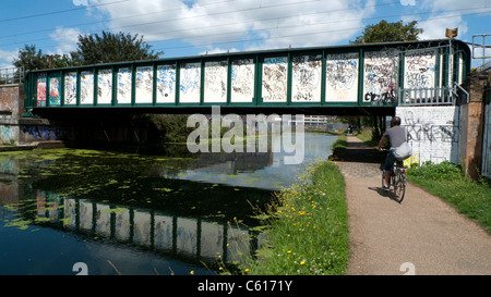 A cyclist riding along the River Lea Navigation canal in East London England UK   KATHY DEWITT Stock Photo
