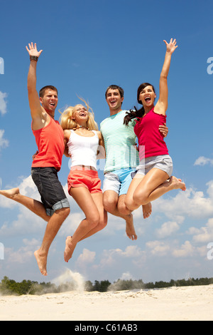 Portrait of four jumping happy people Stock Photo