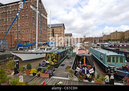 Canal narrow boats and yachts and other river craft moored up at the newly restored docks in Gloucester, Gloucestershire England Stock Photo