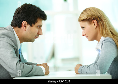 Profiles of serious employees looking at each other Stock Photo