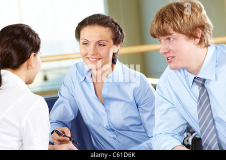 Portrait of confident business partners interacting with each other Stock Photo