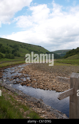 River Swale and public footpath signpost near Muker, Swaledale, North Yorkshire Stock Photo