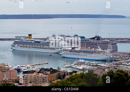 Several cruise ships docked, moored in the harbor at Palma Mallorca showing city and buildings in the foreground. Stock Photo