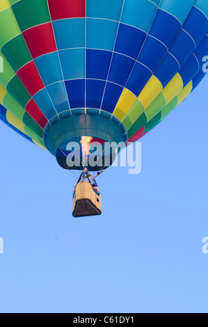 Hot-air balloon floating with view of gondola and burner ignition from below Stock Photo