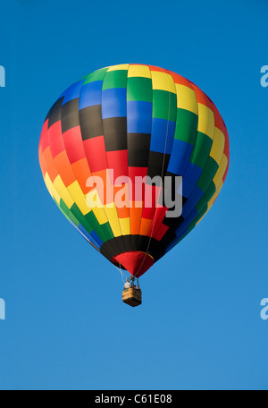 Colorful hot-air balloon floating against blue sky Stock Photo