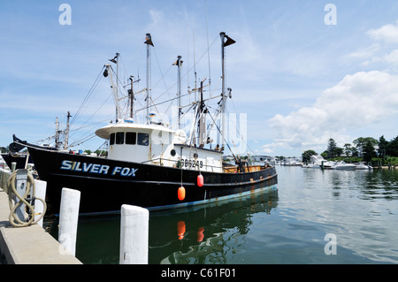Fishing boat Silver Fox docked in Hyannis Harbor, Cape Cod, USA on a clear blue sky summer day. Stock Photo