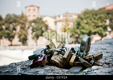 Love Padlocks tied to stone bridge, Verona Italy Stock Photo