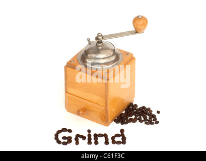 Wood coffee grinder with coffee beans and the word, grind in letters on a white background. Stock Photo