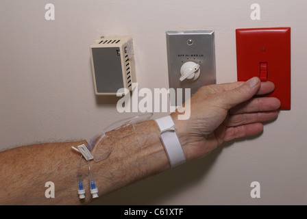 Switching on red light switch. Stock Photo