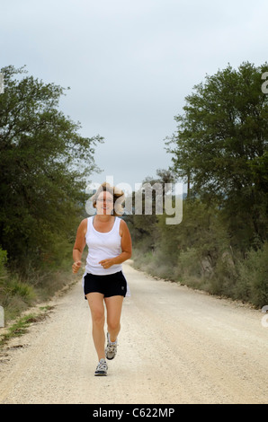 Mature woman jogging Stock Photo
