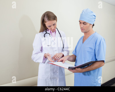Doctor and nurse studying information from document Stock Photo