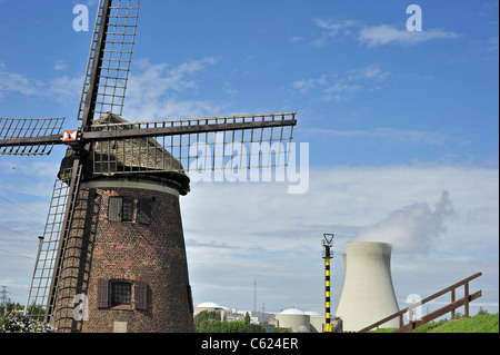The windmill Scheldedijkmolen and cooling towers of the Doel Nuclear Power Plant along the river Scheldt at Beveren, Belgium Stock Photo