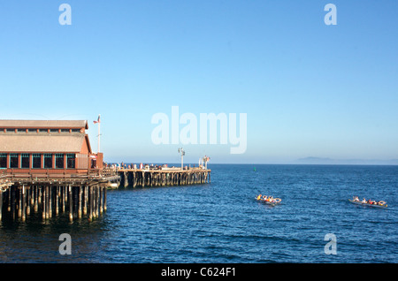 Boats pass by Stearns Wharf in Santa Barbara, California Stock Photo