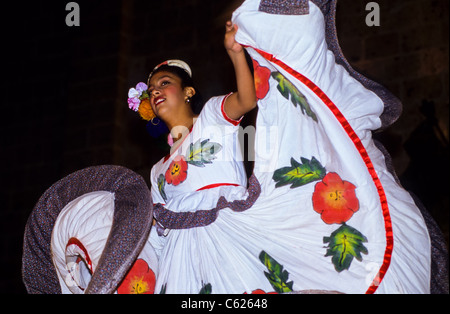 Smiling flamingo danser swinging her gown at night in Mexico Stock Photo