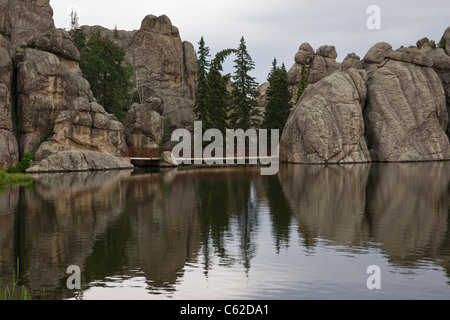 Granite rocks outcroppings and trees reflections in Sylvan Lake in Custer State Park Black Hills South Dakota USA landscape Stock Photo