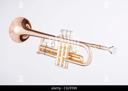 A gold trumpet isolated against a white background in the horizontal format. Stock Photo