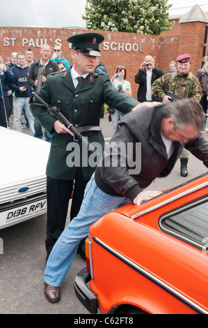 Men dressed in RUC and Army uniforms reenact a stop and search in ...