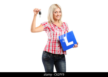 Happy teenager holding a car key and L plate Stock Photo