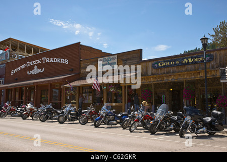 A row of motorcycles Harley Davidson parked on a street in historic downtown of Hill City in Black Hills South Dakota USA US horizontal  hi-res Stock Photo