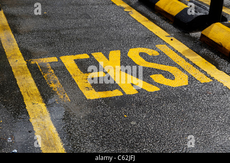 Teksi written on the road of a taxi cab rank in Kuala Lumpur, Malaysia Stock Photo