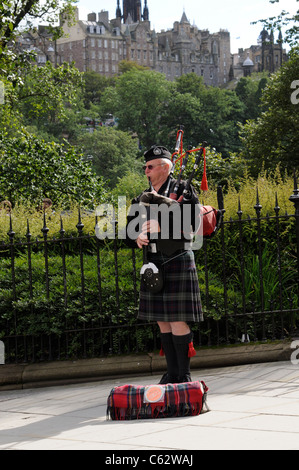 Portrait of a piper playing bagpipes on Princes Street Edinburgh Scotland UK Stock Photo