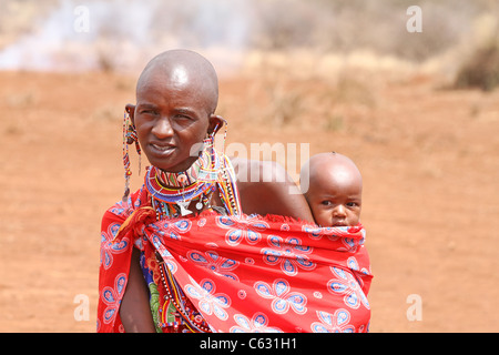 MASAI MARA, KENYA - JULY-2: unidentified African women from Masai tribe with baby by traditional welcome dance on July 2, 2011 Stock Photo