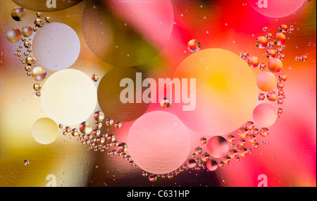 Abstract oil droplets in water reflecting the colors of a background to give a planet effect Stock Photo