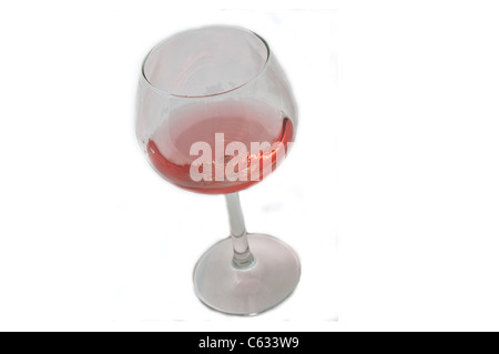 This single long stemmed glass has blush wine in a diagonal composition, isolated on a white background. Stock Photo