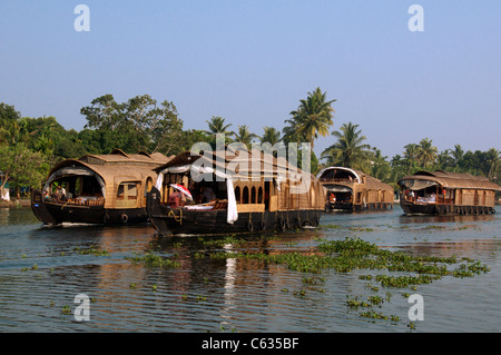 Floatilla of large houseboats Backwaters Kerala South India Stock Photo