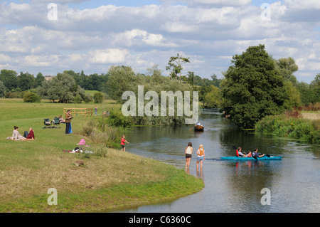 Many people enjoying a summer's day by the River Stour at Dedham, Essex, England. Stock Photo