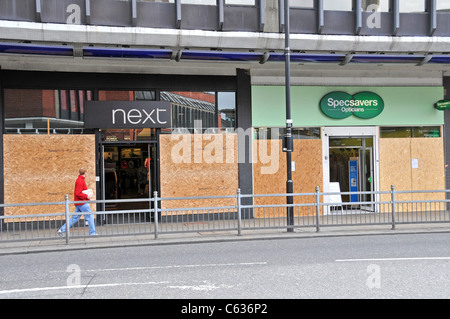 Specsavers Next stores Wood Green London Riots looted shops boarded up smashed windows Stock Photo