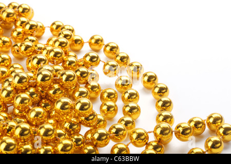 Golden color beads on white background. Stock Photo