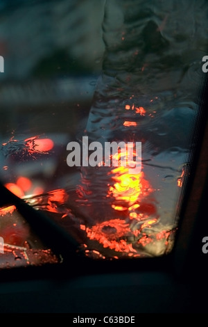 raindrops on the car glass in the light of lamps Stock Photo