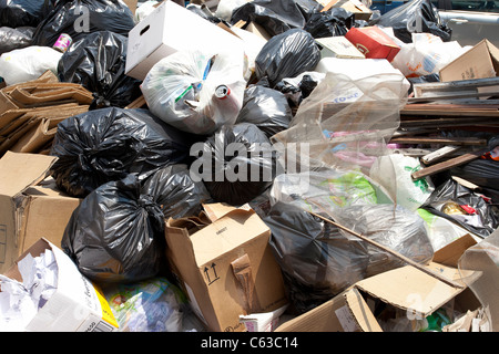 While the garbage men go on strike, the trash piles up in the streets of Naples, Italy, with plastic bags and cardboard boxes. Stock Photo