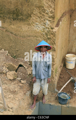 Man cutting bricks straight from the ground Stock Photo