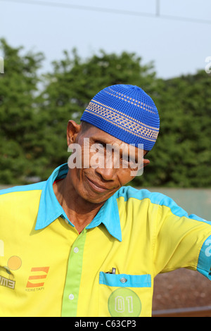 Portrait of baggage handler smoking a cigarette at Gambir train station. Stock Photo
