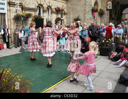 Young girls dance with Appalachian clog dancers 'Step This Way' performing at Saltburn Folk Festival, North East England, UK Stock Photo