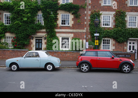 Nissan Figaro and BMW Mini, parked back to back Stock Photo