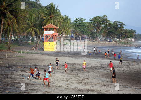 Locals playing football game on the beach at Pantai Karang Haru. Cisolok, West Java, Java, Indonesia, South-East Asia, Asia Stock Photo