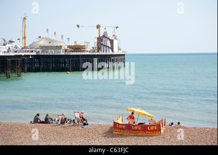 Brighton sea front with beach and fun fair on pier Stock Photo