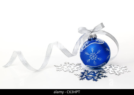 Blue christmas ball with silver ribbon bow and snowflake on white background. Stock Photo