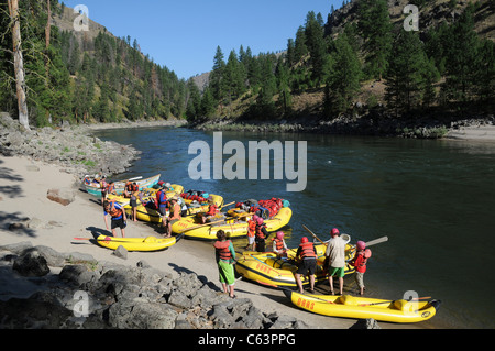 Rubber paddle boats, gear boat, dory and inflatable kayaks with the O.A.R.S. group on Main Salmon River in Idaho Stock Photo