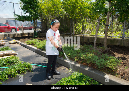 Students, family, friends and volunteers participate in a work day at a school in New York Stock Photo