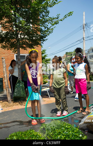 Students, family, friends and volunteers participate in a work day at a school in New York Stock Photo