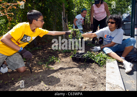 Students, family, friends and volunteers participate in a work day at a school in New York Stock Photo