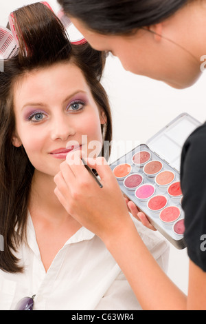 Make-up artist woman fashion model apply lipstick from color palette Stock Photo