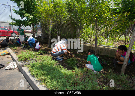 Students, family, friends and volunteers participate in a work day at a school in New York Stock Photo