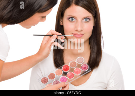 Make-up artist woman fashion model apply lipstick from color palette Stock Photo
